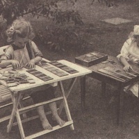 Children in a Berlin Children's House have taken the colour tablets out of their box and mixed them up. The little girl on the left is putting the colours in matching pairs; the little girl on the right is arranging the tablets colour by colour in order of intensity. Postcard published by the DMG (Ger-man Montessori Society), around 1927. Photograph: Clara Grunwald - T. Müller, R. Schneider, <em>Lehrmaterialien 1913-1935. Möbel und Architektur. Techning Meterials 1913-1935. Furniture and Architecture</em>, München, Prestel Verlag, 2002, p.92$$$452