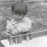 Fitting the cylinders into the right holes, Berlin 1927. This exercise, initially with just one block of cylinders, is popular with children as young as two and a half to three. Material for developing the ability to gauge the size of objects by sight or touch - T. Müller, R. Schneider, <em>Lehrmaterialien 1913-1935. Möbel und Architektur. Techning Meterials 1913-1935. Furniture and Architecture</em>, München, Prestel Verlag, 2002, p.90$$$446
