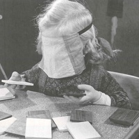 The girl compares the weight of the wooden tablets; she will set aside the lightest and the heaviest. The tablets are colour-coded so that the children realise themselves if they have made a mistake. Montessori nursery, Berlin-Tempelhof, 1950 - T. Müller, R. Schneider, <em>Lehrmaterialien 1913-1935. Möbel und Architektur. Techning Meterials 1913-1935. Furniture and Architecture</em>, München, Prestel Verlag, 2002, p.94$$$457
