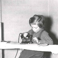 The girl is working with an electric iron which is fitted with a special safety plug. The teacher supervises the switching on and off of the iron. Montessori nursery, Berlin-Tempelhof, 1955 - T. Müller, R. Schneider, <em>Lehrmaterialien 1913-1935. Möbel und Architektur. Techning Meterials 1913-1935. Furniture and Architecture</em>, München, Prestel Verlag, 2002, p.79$$$412