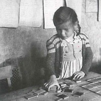 Eight year old girl working with the colour tablets, Montessori class, Berlin-Tegel, 1947. The normal age at which children choose this activity is four or five. The war was on when this girl was that age; she and other children who suffered the same fate worked for weeks with the colours - T. Müller, R. Schneider, <em>Lehrmaterialien 1913-1935. Möbel und Architektur. Techning Meterials 1913-1935. Furniture and Architecture</em>, München, Prestel Verlag, 2002, p.92$$$453