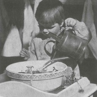 Learning to handle water and breakable vessels with care in a Berlin Children's House. Photograph from 1927 - T. Müller, R. Schneider, <em>Lehrmaterialien 1913-1935. Möbel und Architektur. Techning Meterials 1913-1935. Furniture and Architecture</em>, München, Prestel Verlag, 2002, p.81$$$423