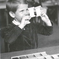 A five year old boy is holding up two similar colour tablets in order to be able to see better which shade is darker. Montessori nurs-ery, Berlin-Tegel, 1949 - T. Müller, R. Schneider, <em>Lehrmaterialien 1913-1935. Möbel und Architektur. Techning Meterials 1913-1935. Furniture and Architecture</em>, München, Prestel Verlag, 2002, p.92$$$454